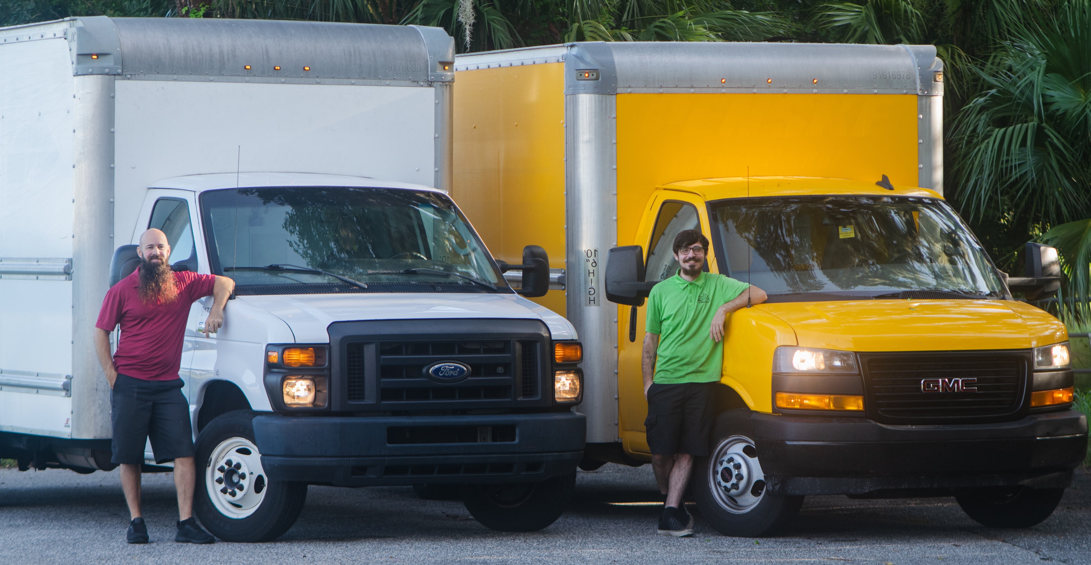 D.K. and Josh standing by their bread delivery trucks.